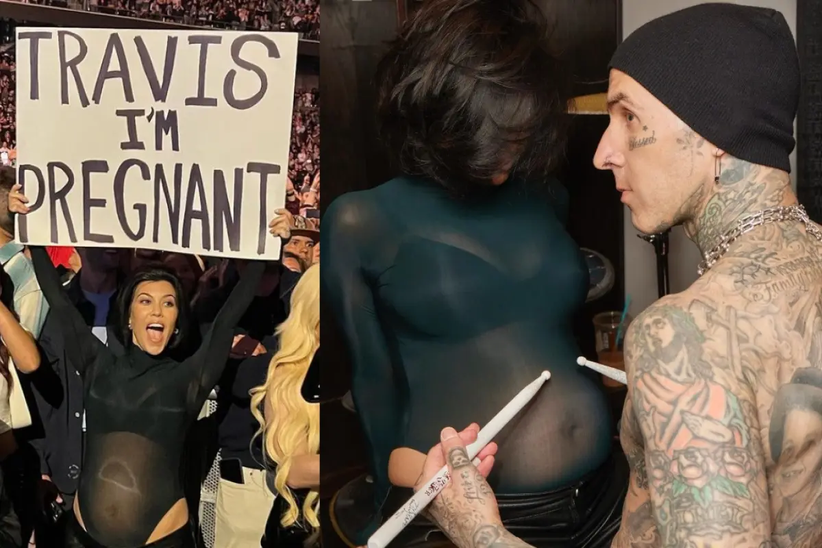 Kourtney kardashian en un recital de travis barker mostrando un cartel con su embarazo, a su lado travis barker