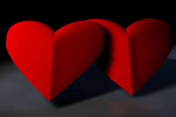 dos corazones plegados sobre un fondo negro