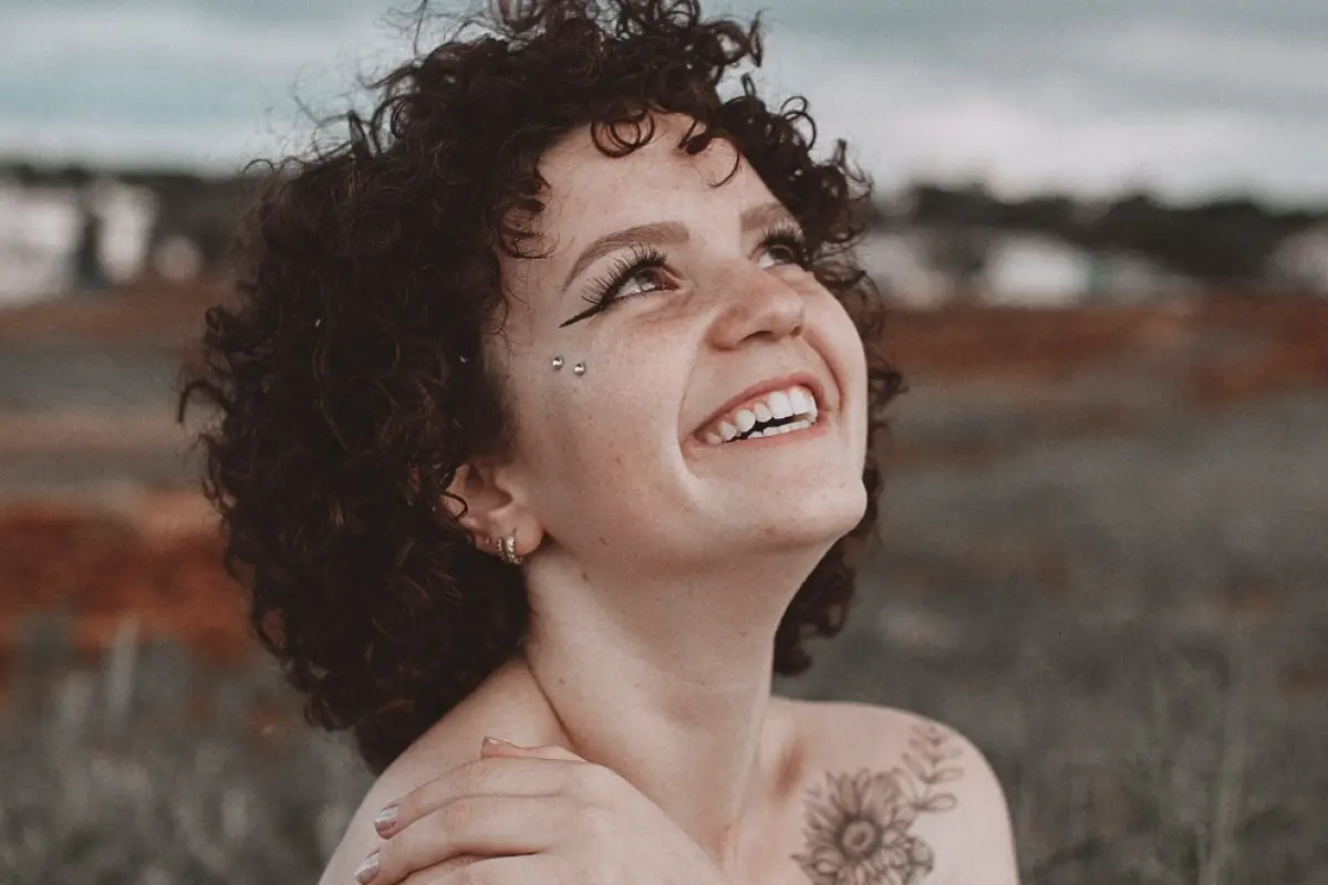 mujer sonriente mira al cielo