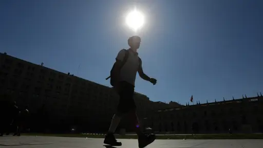 un niño caminando frente a La Moneda